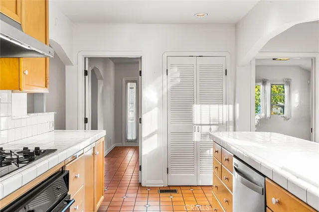 a kitchen with a sink and a stove
