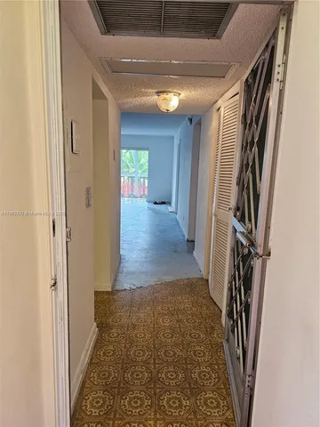 a view of hallway with wooden floor and stairs