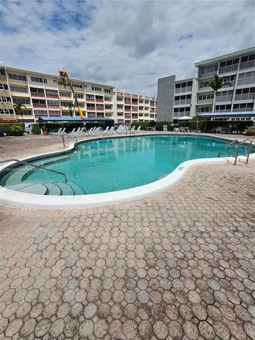 a view of a swimming pool and a yard