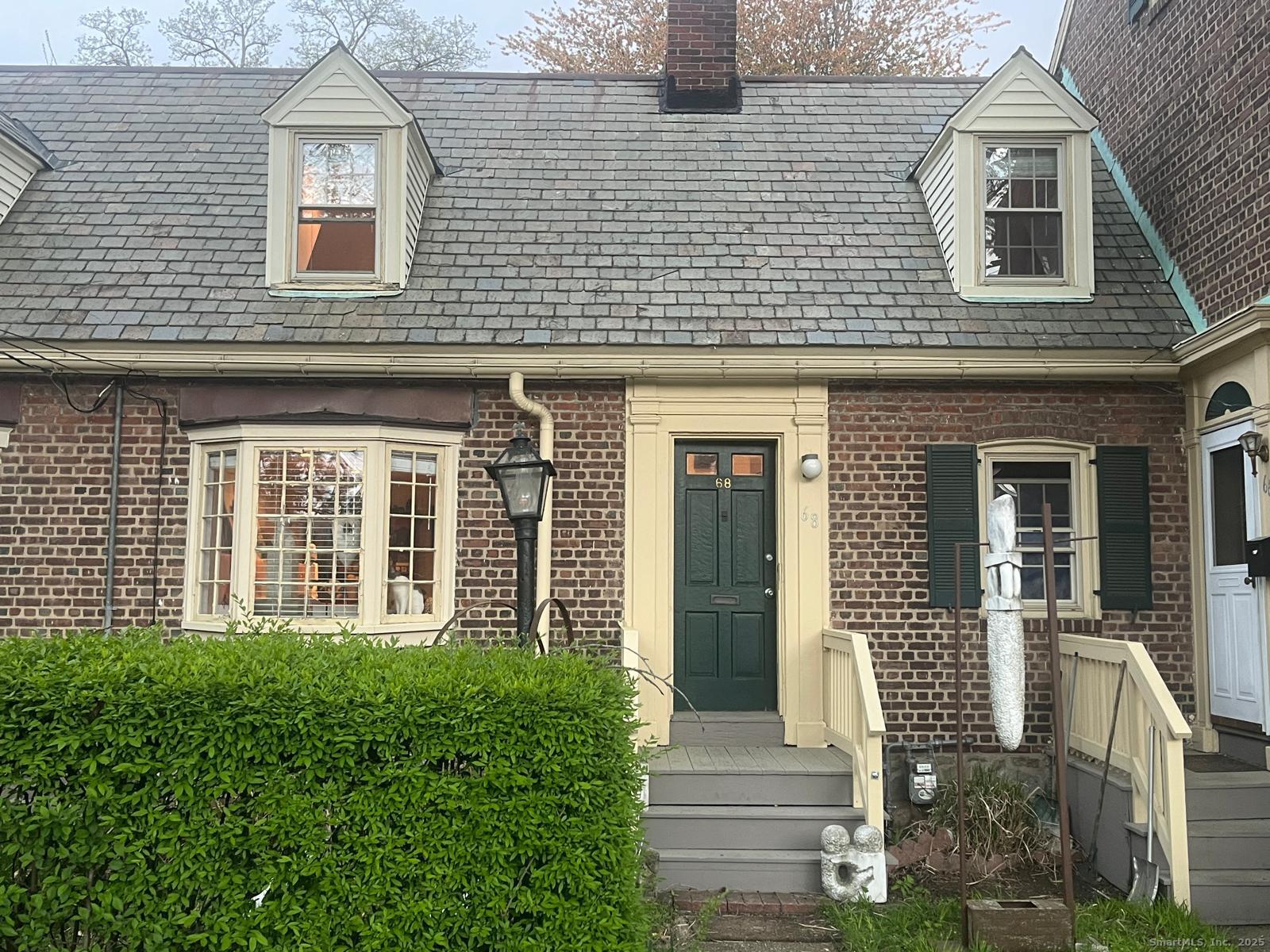 a view of a brick house with many windows