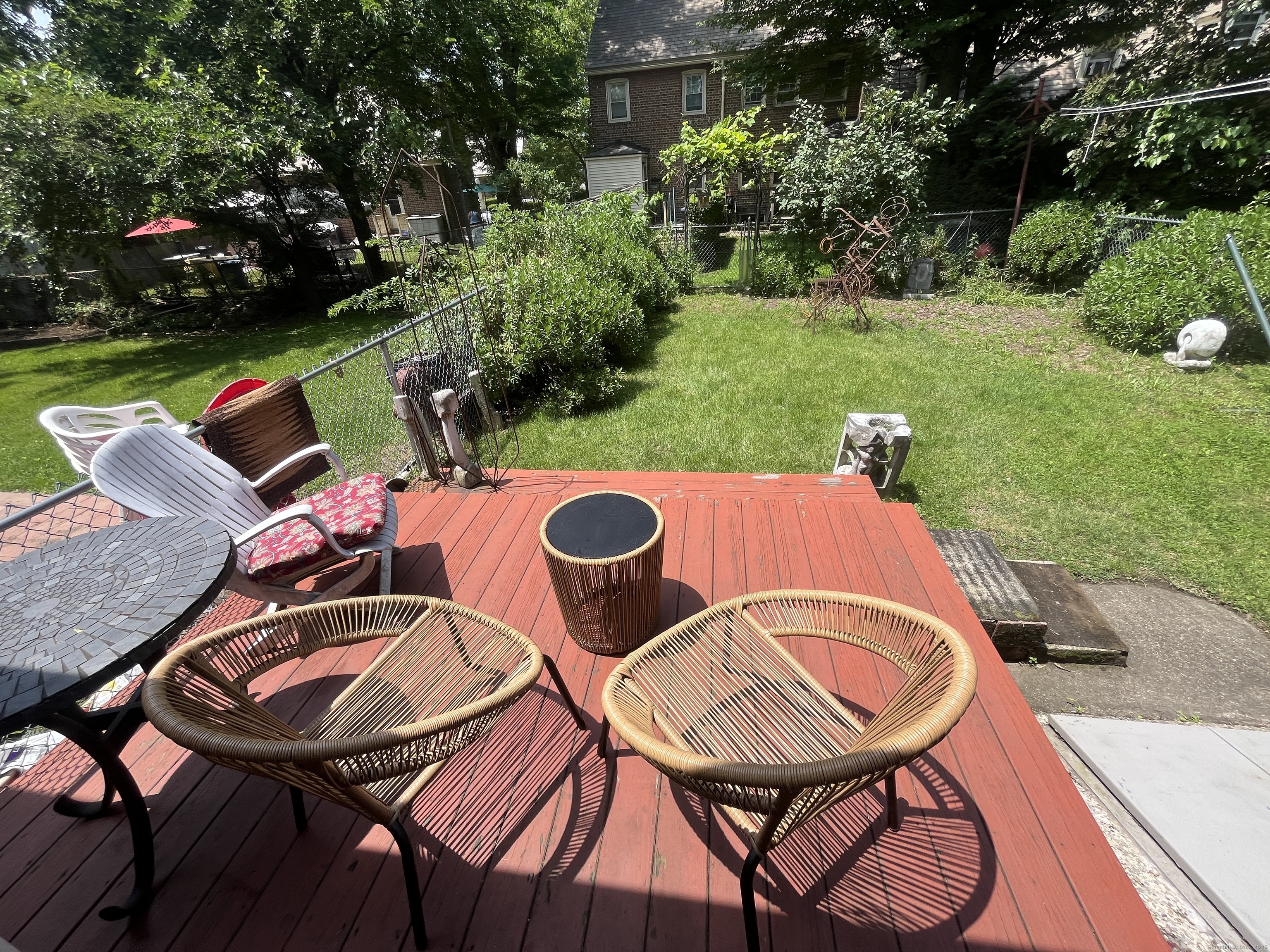 68 Cole Street Bridgeport, CT 06604 - Photo 18 of 31 a view of a backyard with table and chairs with wooden floor and fence