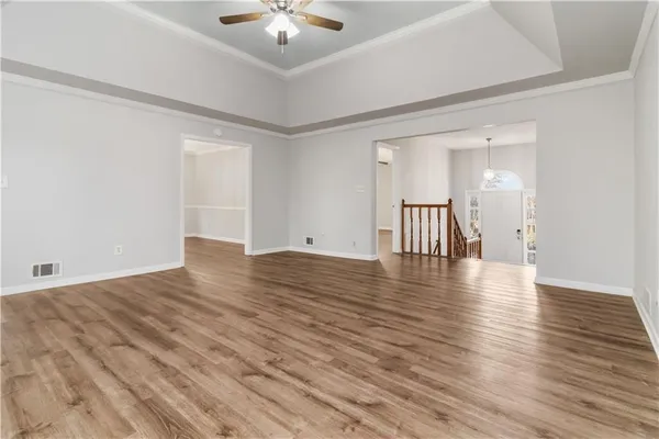 a view of an empty room with wooden floor