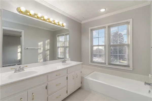 a bathroom with a large tub sink and mirror