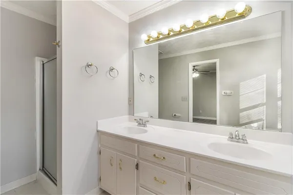 a bathroom with a double vanity sink and a mirror