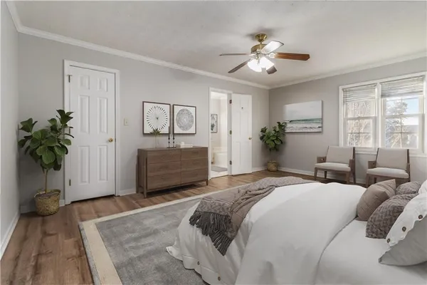 a spacious bedroom with a bed and a chandelier