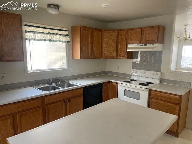 a kitchen with a sink stove top oven and cabinets