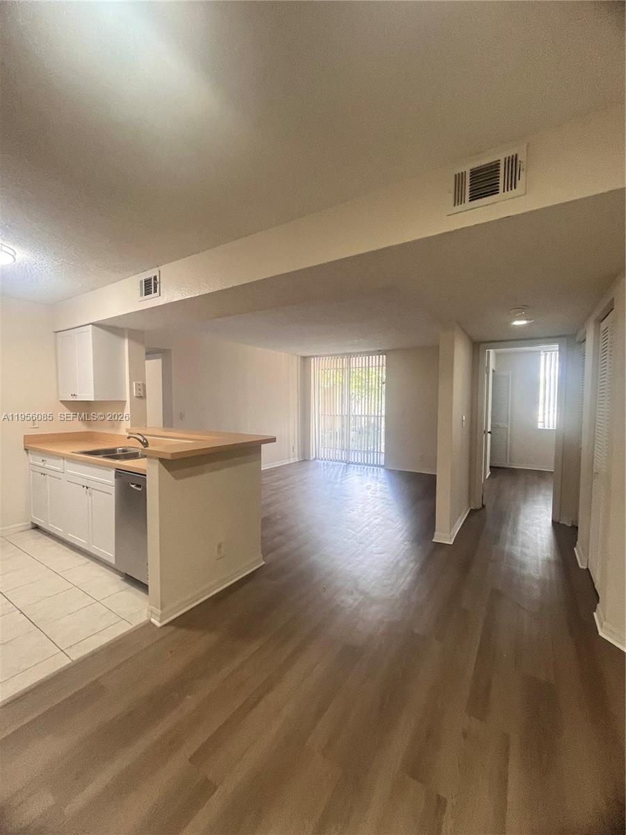 4035 West McNab Road, Unit F206 Pompano Beach, FL 33069 - Photo 15 of 20 a view of a kitchen with a sink and a refrigerator
