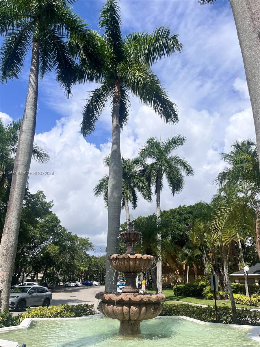 4035 West McNab Road, Unit F206 Pompano Beach, FL 33069 - Photo 17 of 20 a garden with palm trees