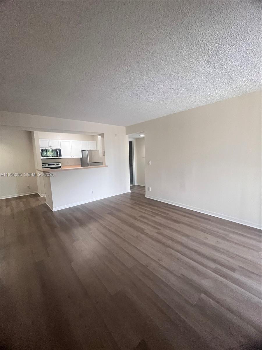 4035 West McNab Road, Unit F206 Pompano Beach, FL 33069 - Photo 7 of 20 a view of empty room with wooden floor