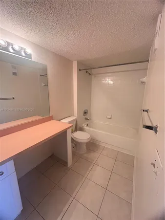 a bathroom with a bathtub and a toilet