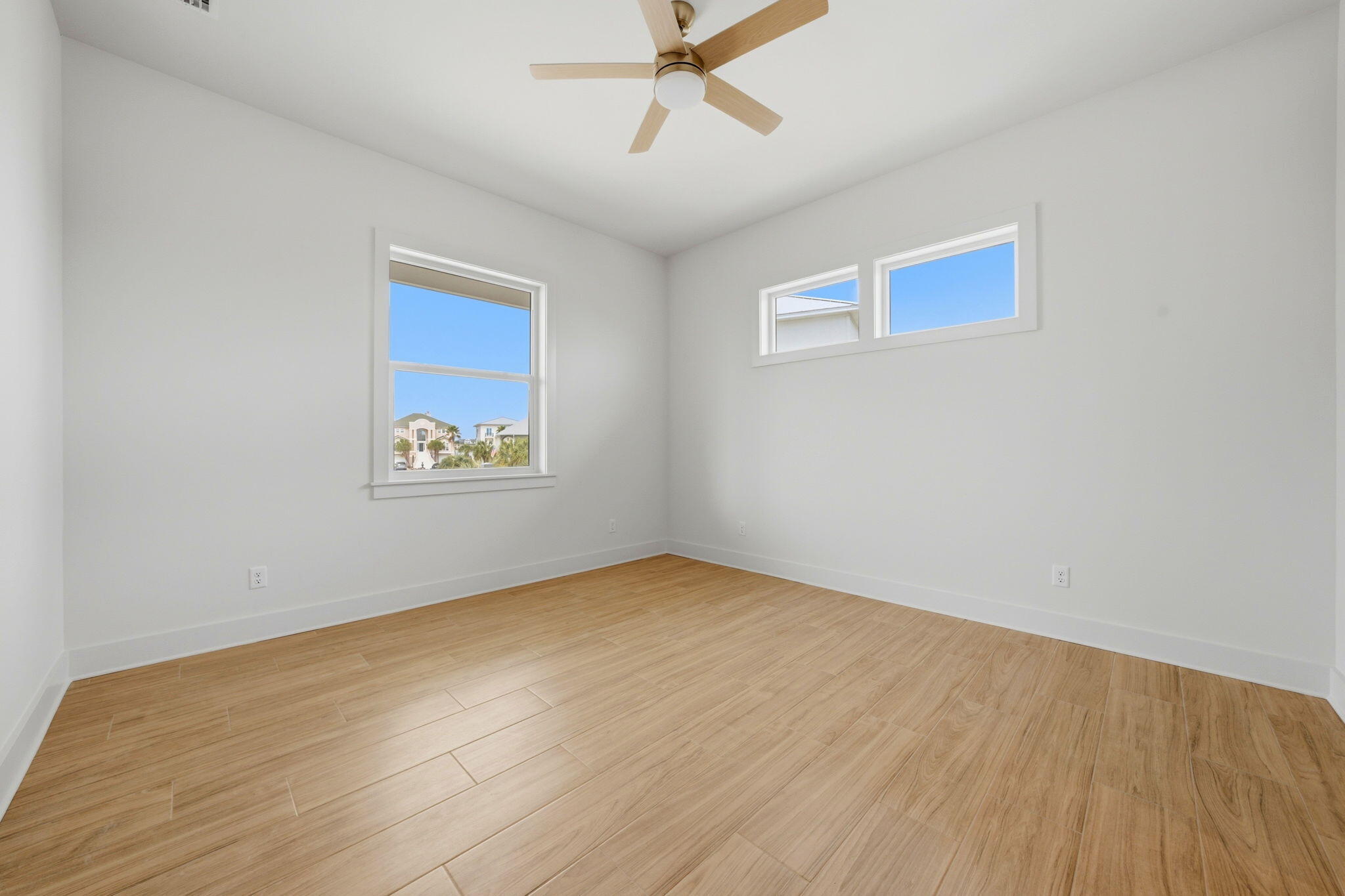 425 Gulfview Lane Perdido Key, FL 32507 - Photo 18 of 71 an empty room with a ceiling fan and windows