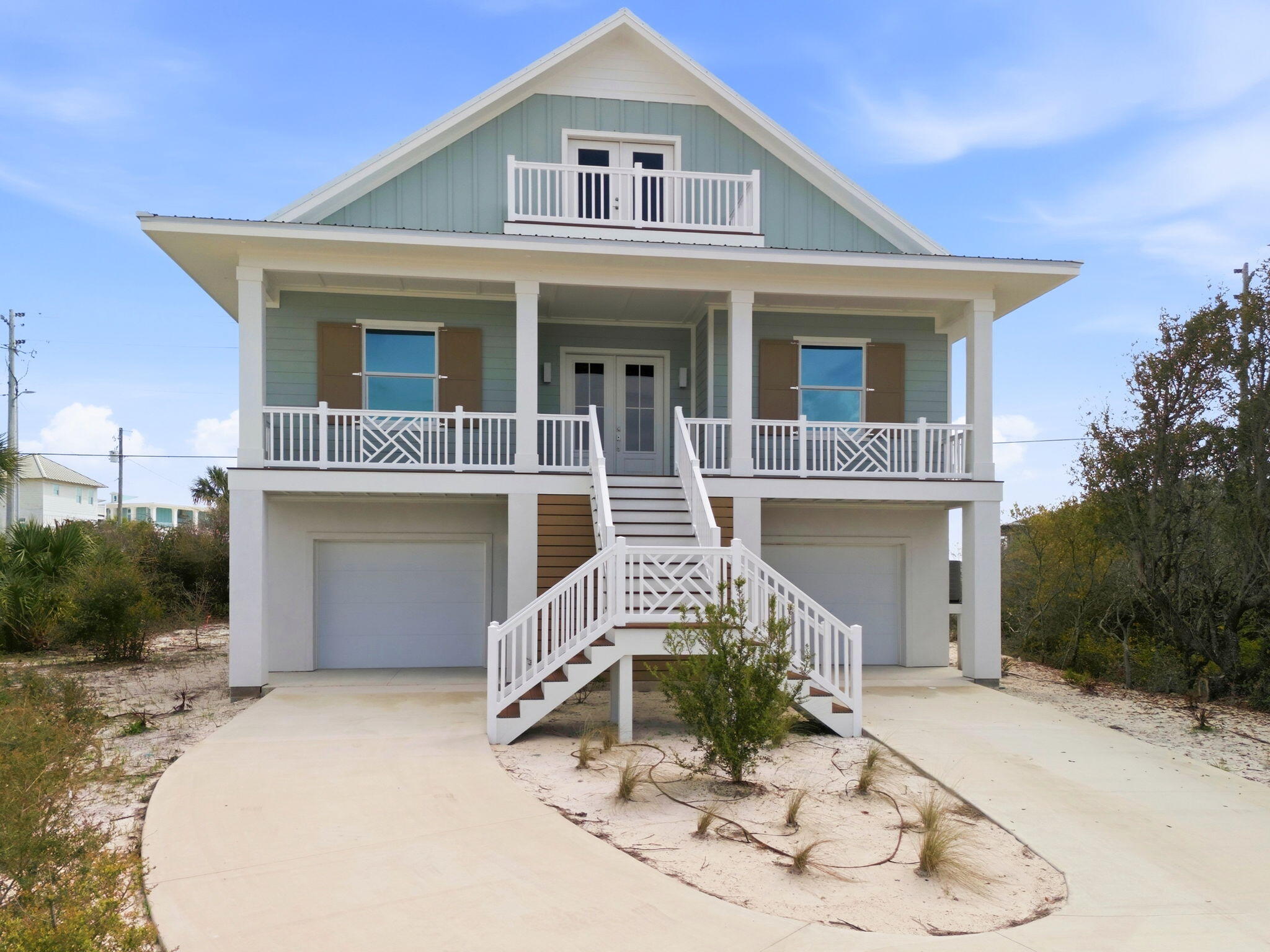 425 Gulfview Lane Perdido Key, FL 32507 - Photo 4 of 71 a front view of a house with a yard and garage