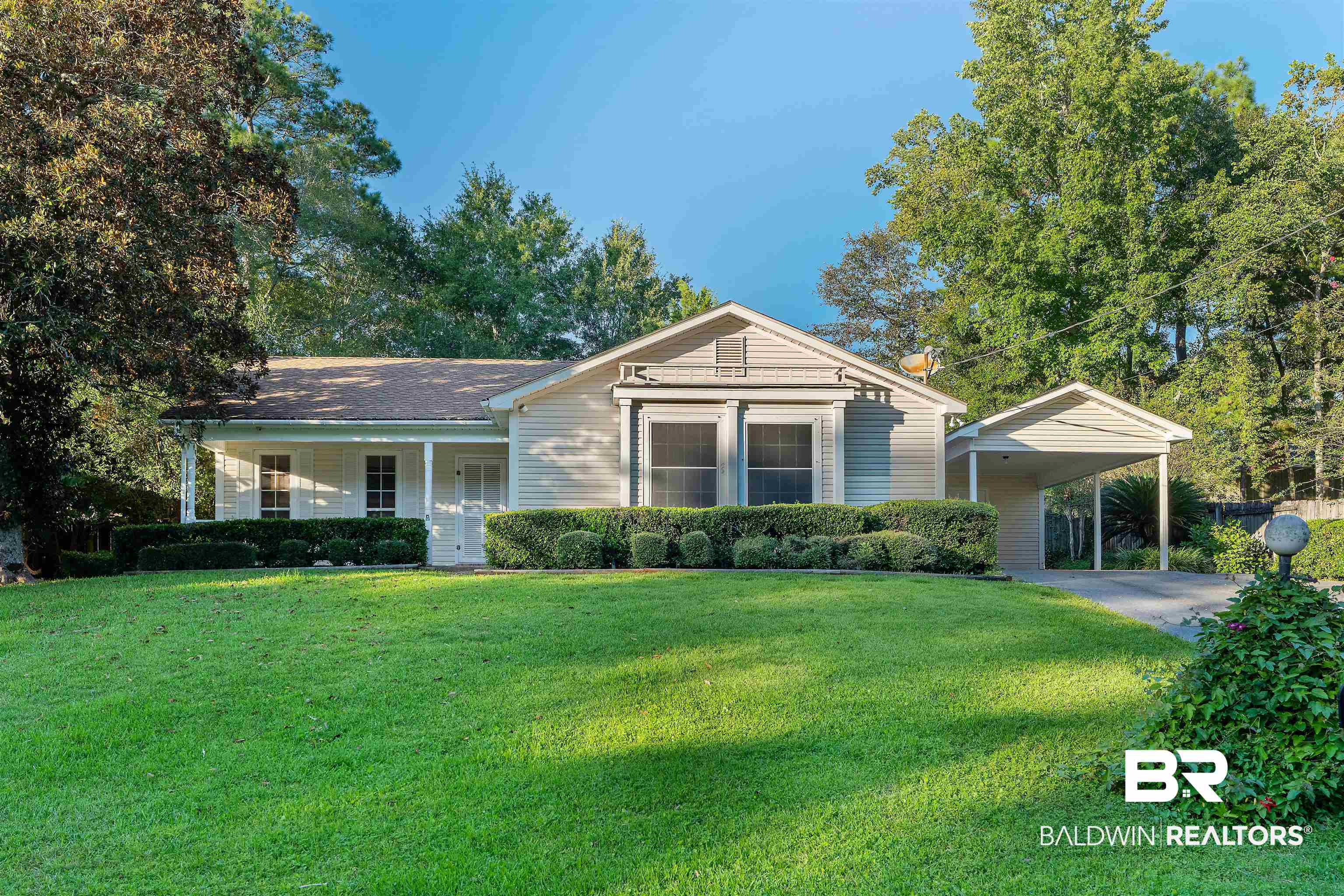 438 Ridgewood Drive Daphne, AL 36526 - Photo 1 of 28 View of front facade featuring a front yard, covered porch, and a carport