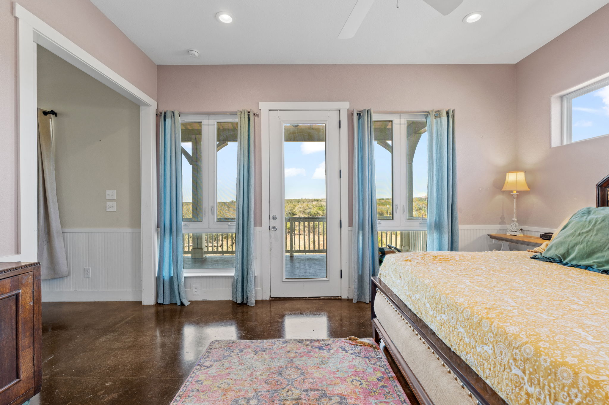 6350 Mt Sharp Road, Unit B Wimberley, TX 78676 - Photo 12 of 34 a spacious bedroom with a large bed and a large window