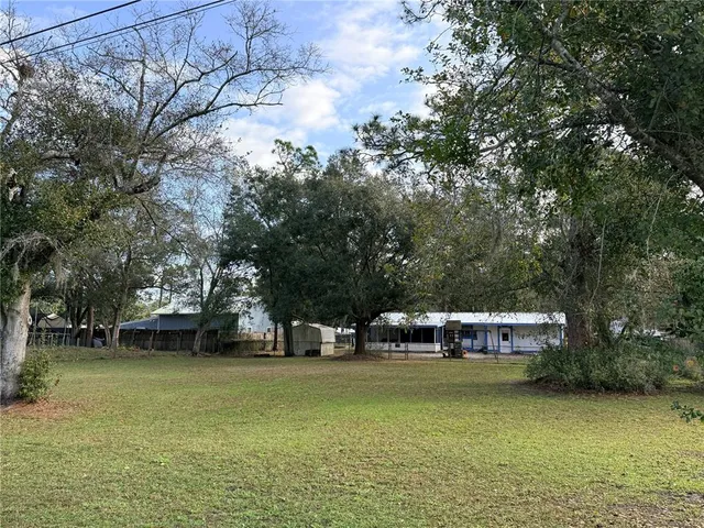 a view of a house with pool and sitting area