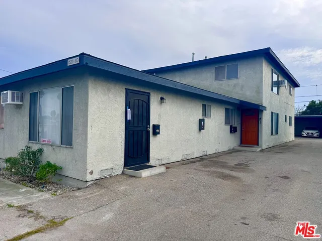 a view of a house with a wooden fence