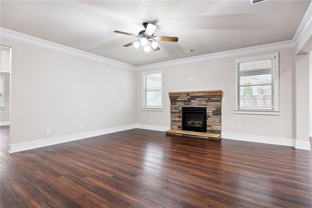 103 Gray Trail Acworth, GA 30101 - Photo 12 of 44 a view of an empty room with wooden floor fireplace and a window