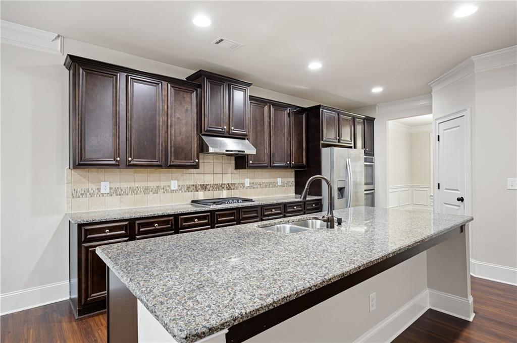 103 Gray Trail Acworth, GA 30101 - Photo 15 of 44 a kitchen with stainless steel appliances granite countertop a sink stove and cabinets