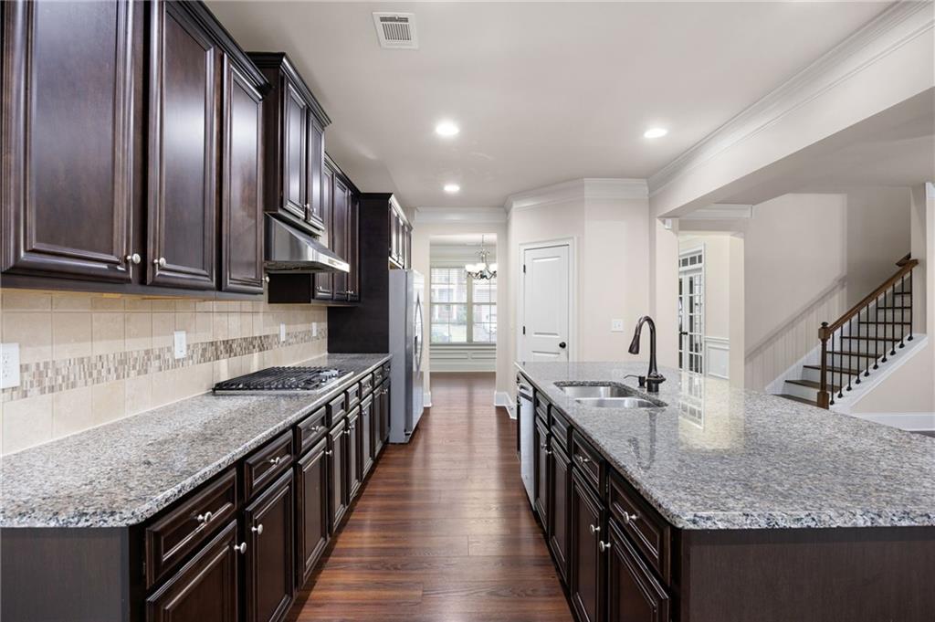 103 Gray Trail Acworth, GA 30101 - Photo 19 of 44 a kitchen with stainless steel appliances granite countertop counter space a sink and cabinets