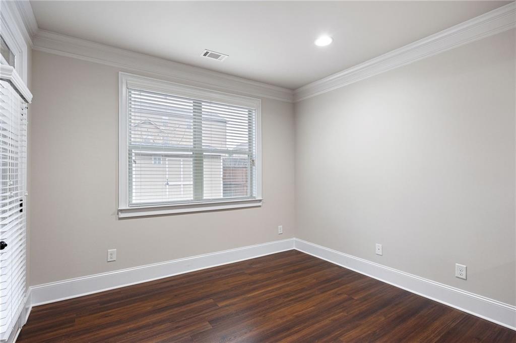 103 Gray Trail Acworth, GA 30101 - Photo 20 of 44 a view of an empty room with wooden floor and a window