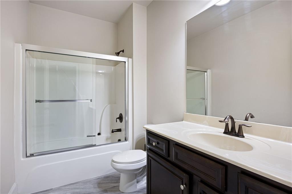 103 Gray Trail Acworth, GA 30101 - Photo 23 of 44 a bathroom with a granite countertop sink toilet and shower