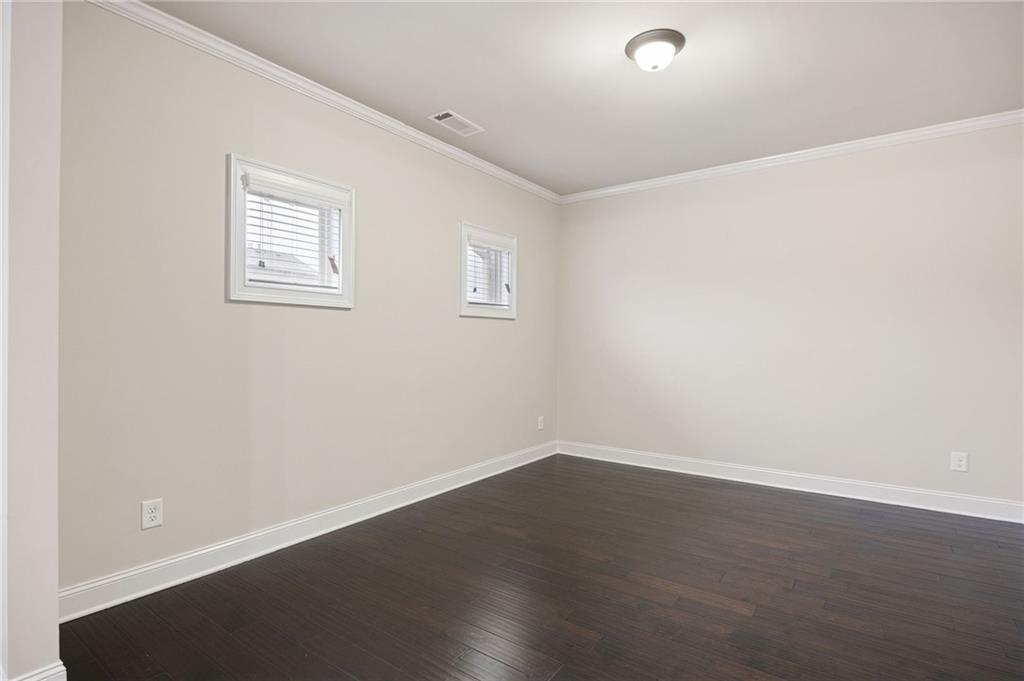 103 Gray Trail Acworth, GA 30101 - Photo 26 of 44 an empty room with wooden floor and windows