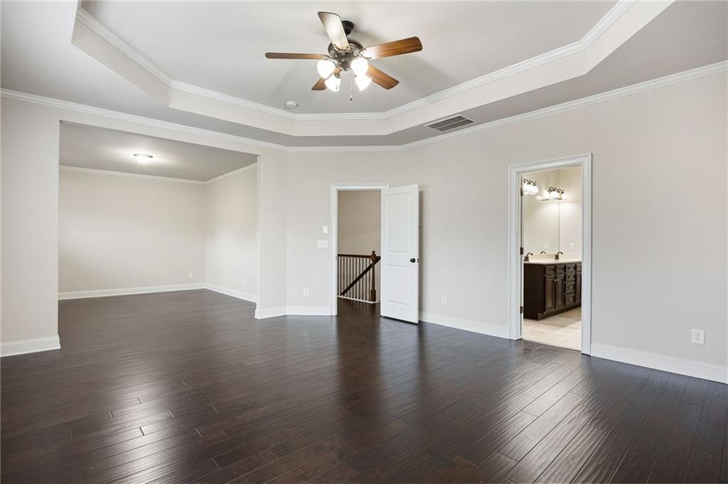 103 Gray Trail Acworth, GA 30101 - Photo 27 of 44 a view of a livingroom with wooden floor and a ceiling fan