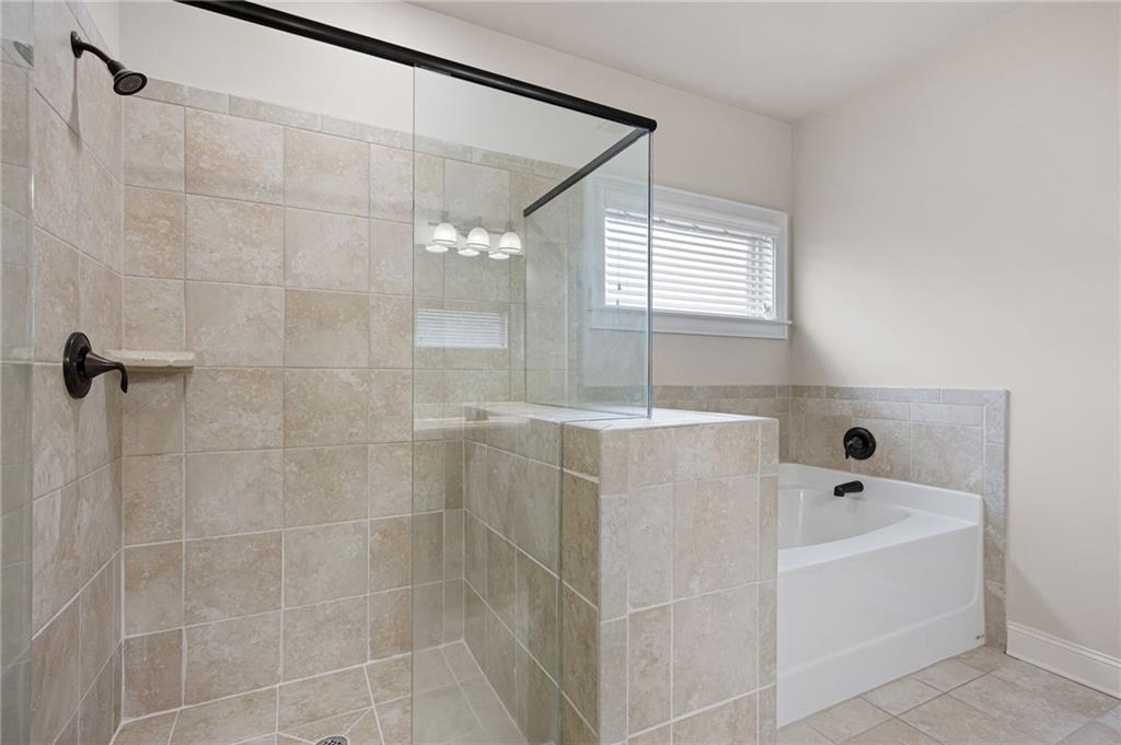 103 Gray Trail Acworth, GA 30101 - Photo 30 of 44 a bathroom with a bathtub and shower