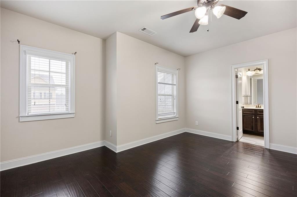 103 Gray Trail Acworth, GA 30101 - Photo 32 of 44 a view of an empty room with a window and wooden floor