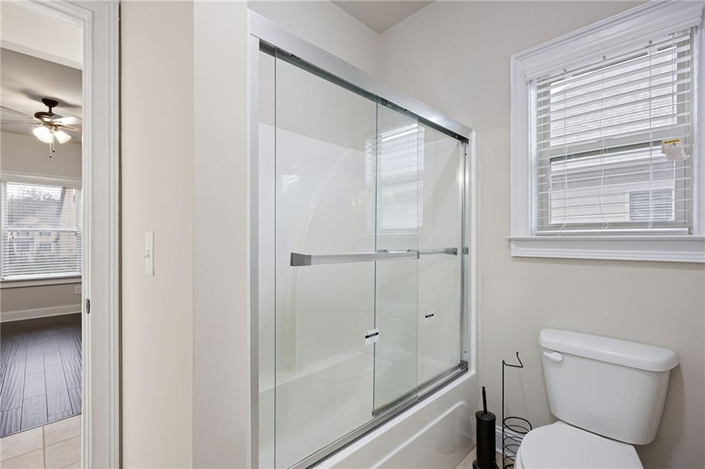 103 Gray Trail Acworth, GA 30101 - Photo 36 of 44 a bathroom with a toilet and a shower