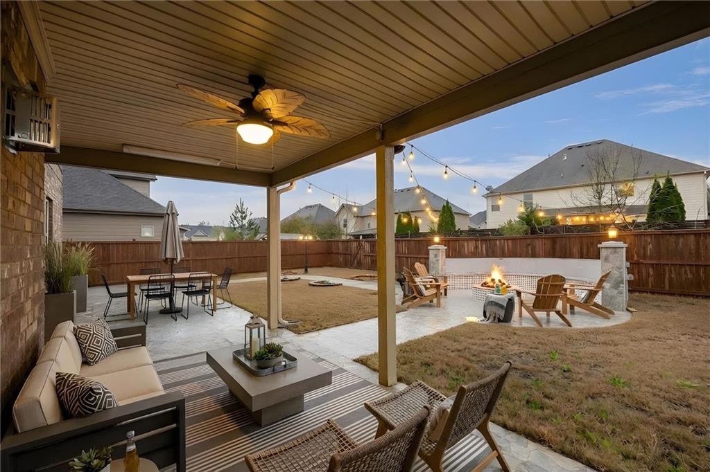 103 Gray Trail Acworth, GA 30101 - Photo 39 of 44 a view of a patio with a dining table and chairs under an umbrella