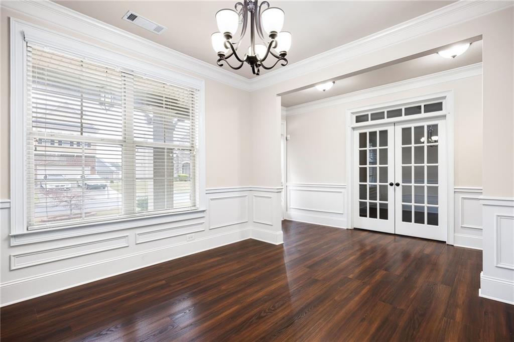 103 Gray Trail Acworth, GA 30101 - Photo 10 of 44 a view of an empty room with wooden floor and a window
