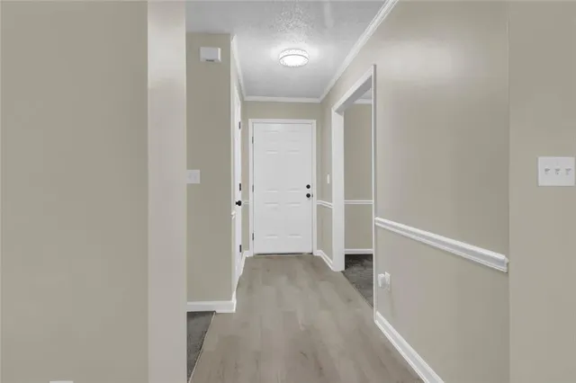 a view of hallway with wooden floor