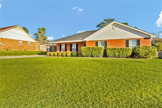 a front view of a house with garden