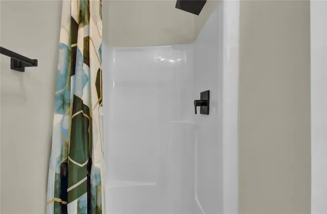 a bathroom with a mirror and a shower