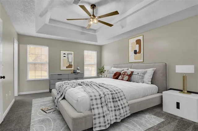 a bedroom with a large bed and a chandelier