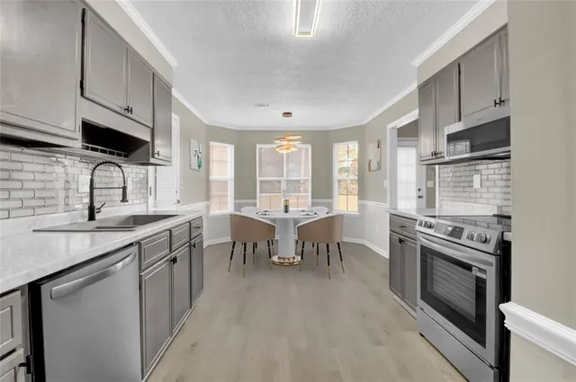 a open kitchen with lots of counter space sink and appliances