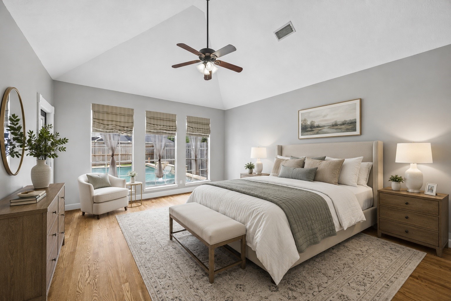 7915 Huddersfield Court Spring, TX 77379 - Photo 7 of 37 First-floor primary bedroom with vaulted ceiling, hardwood floors, backyard access, and tall windows overlooking the pool. - virtually staged