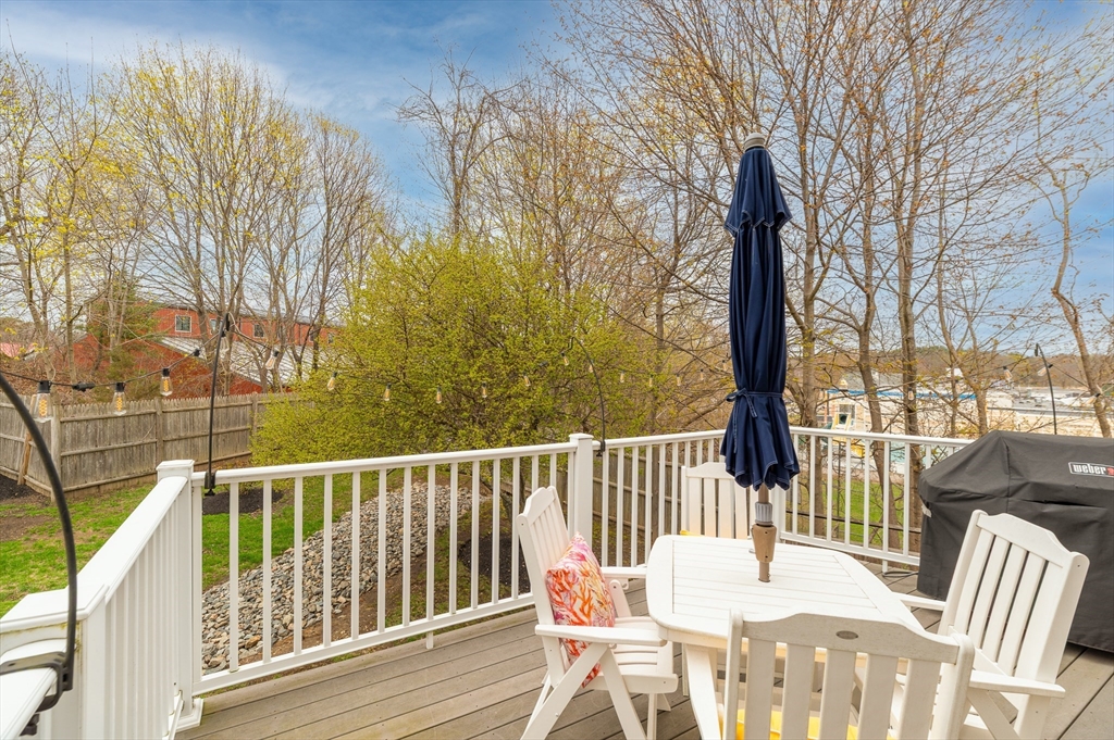 6 Essex Road, Unit 8 Ipswich, MA 01938 - Photo 12 of 35 a view of a chair and table on the deck