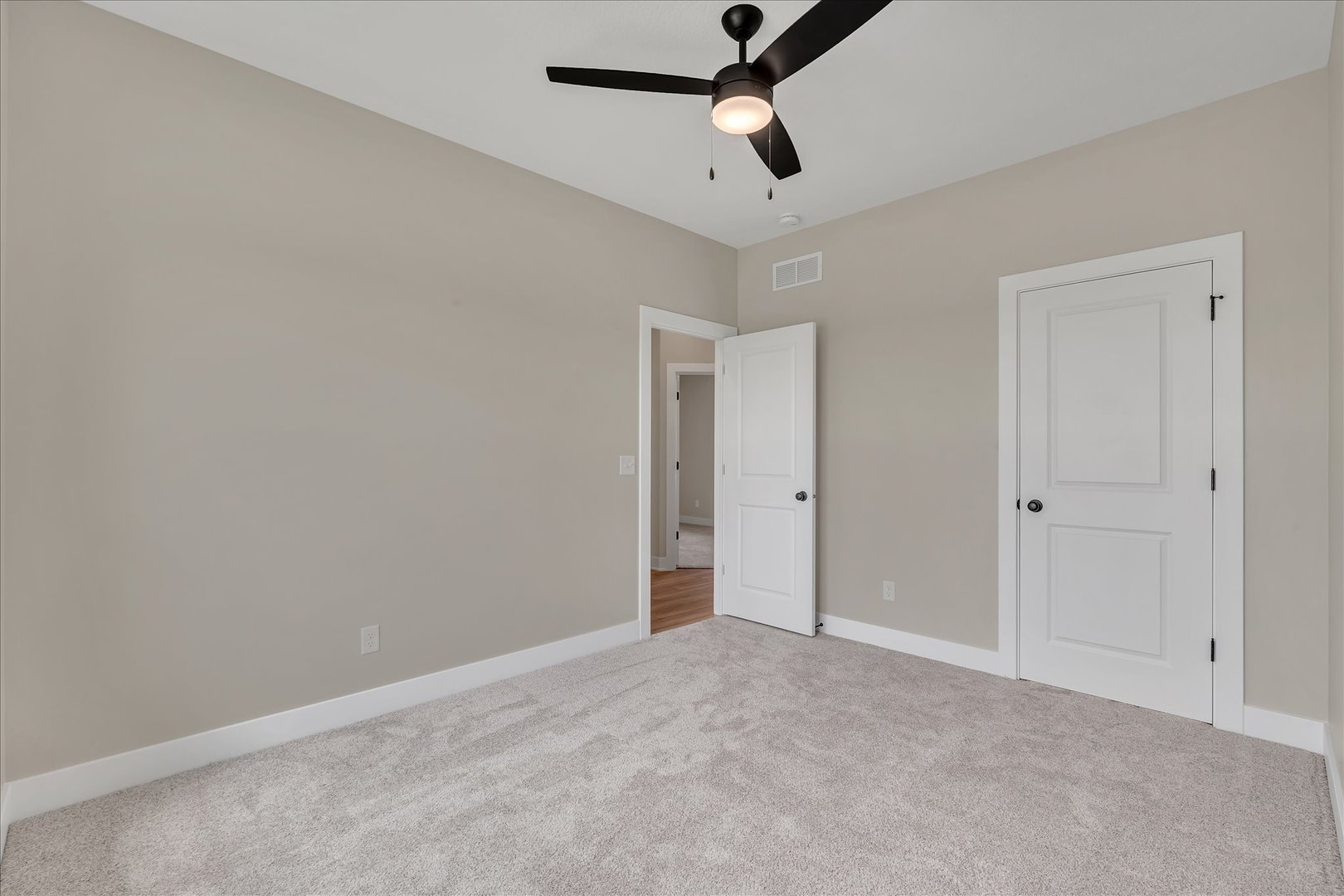 455 Rhonda Road New Liberty, IA 52765 - Photo 41 of 54 an empty room with a ceiling fan and carpet