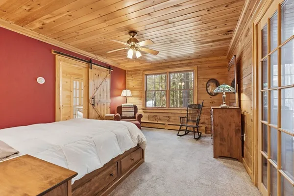 a spacious bedroom with a bed and a chandelier