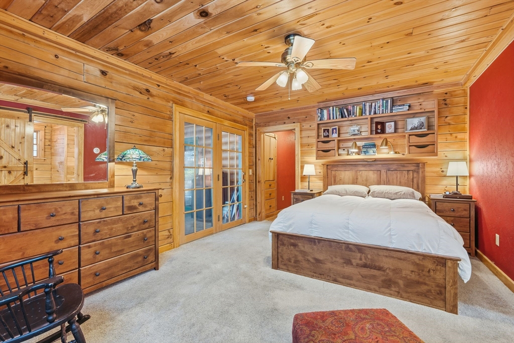 8 Ring Road Chesterfield, MA 01084 - Photo 20 of 42 a spacious bedroom with a large bed and a chandelier