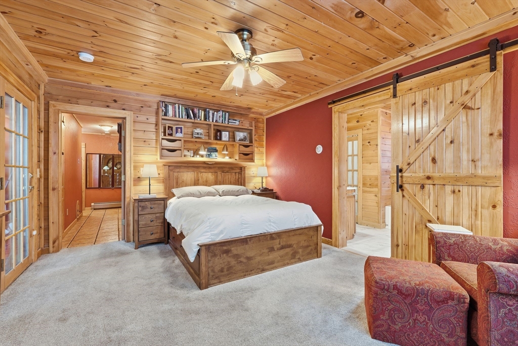 8 Ring Road Chesterfield, MA 01084 - Photo 21 of 42 a spacious bedroom with a bed and a chandelier