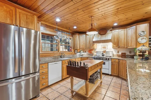a kitchen with stainless steel appliances granite countertop a sink and cabinets