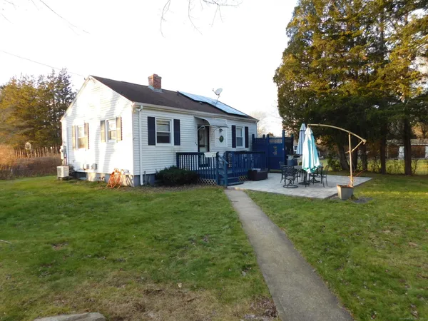 a front view of house with yard and green space