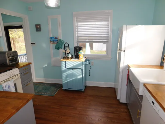 a bedroom with furniture and a wooden floor