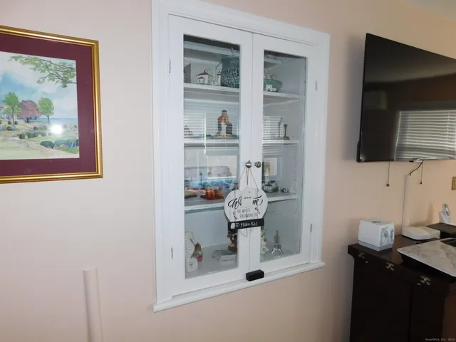 a view of a room with window and wooden floor
