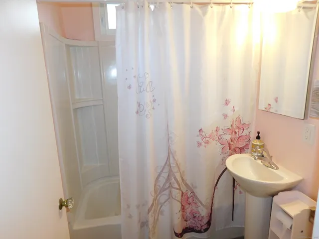 a utility room with dryer washer and stair