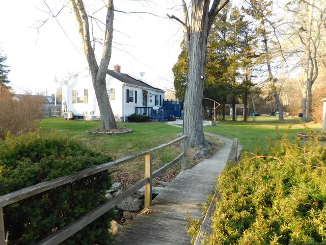 a room with kitchen island a wooden floor and a window