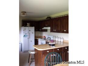 73 Baldwin Road Waymart, PA 18472 - Photo 4 of 6 a kitchen with a sink cabinets and appliances